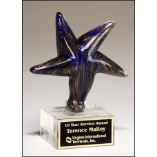 2199 Art glass Star with blue and gold design on clear glass base with felt bottom.